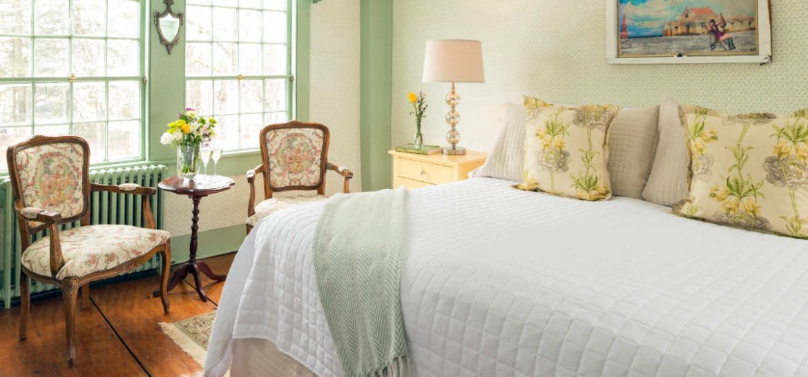 Green room with bed and seating area
