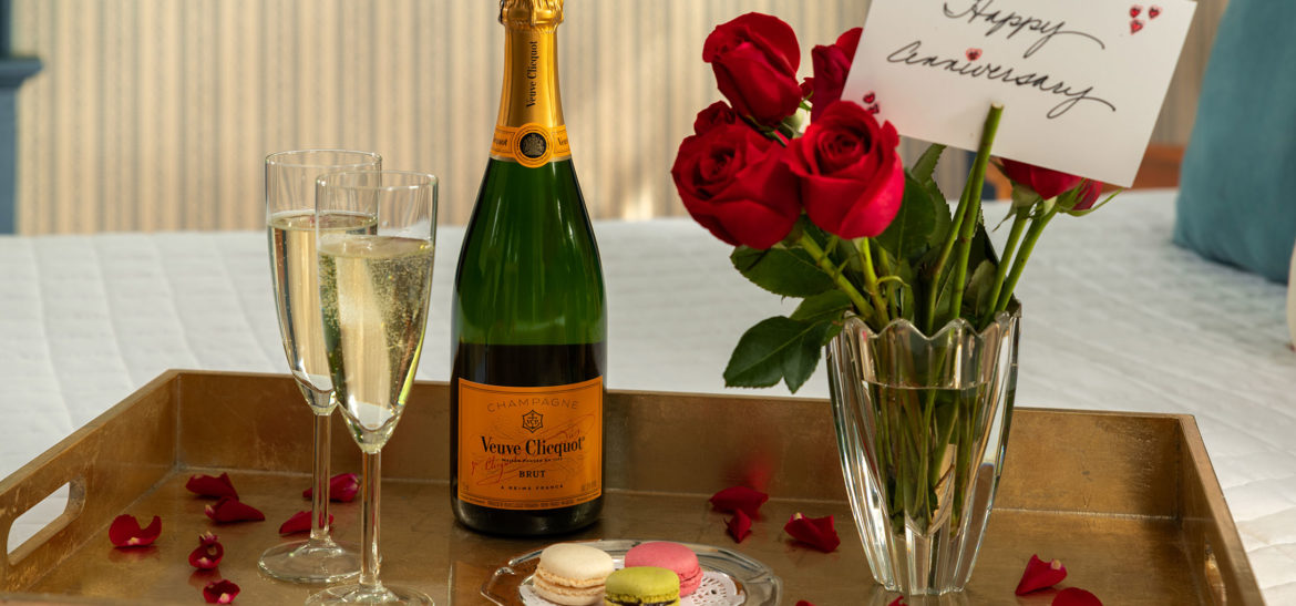 Luxury celebration package with champagne, cake, and flowers