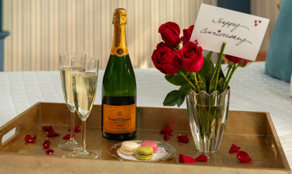 Luxury celebration package with champagne, cake, and flowers